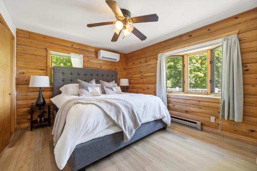 Primary bedroom with bay window overlooking the lake