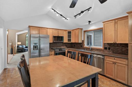 Newer stainless steel appliances, including the stove and microwave, complement this beautifully maintained kitchen