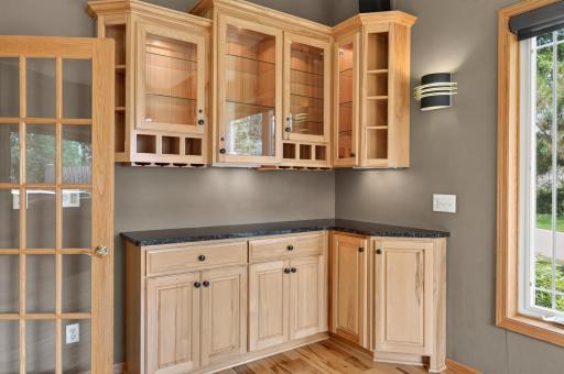 Illuminated glass cabinetry creates a warm, sophisticated ambiance.