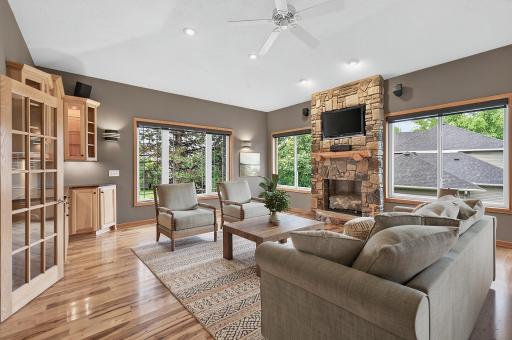 Anchored by a stunning stone fireplace and complete with a built-in bar, this versatile living space is perfect for entertaining, relaxing, or creating the game room you've always wanted.
