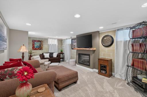 Lower level family room with electric fireplace.