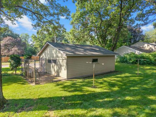 Fenced dog pen or storage along garage