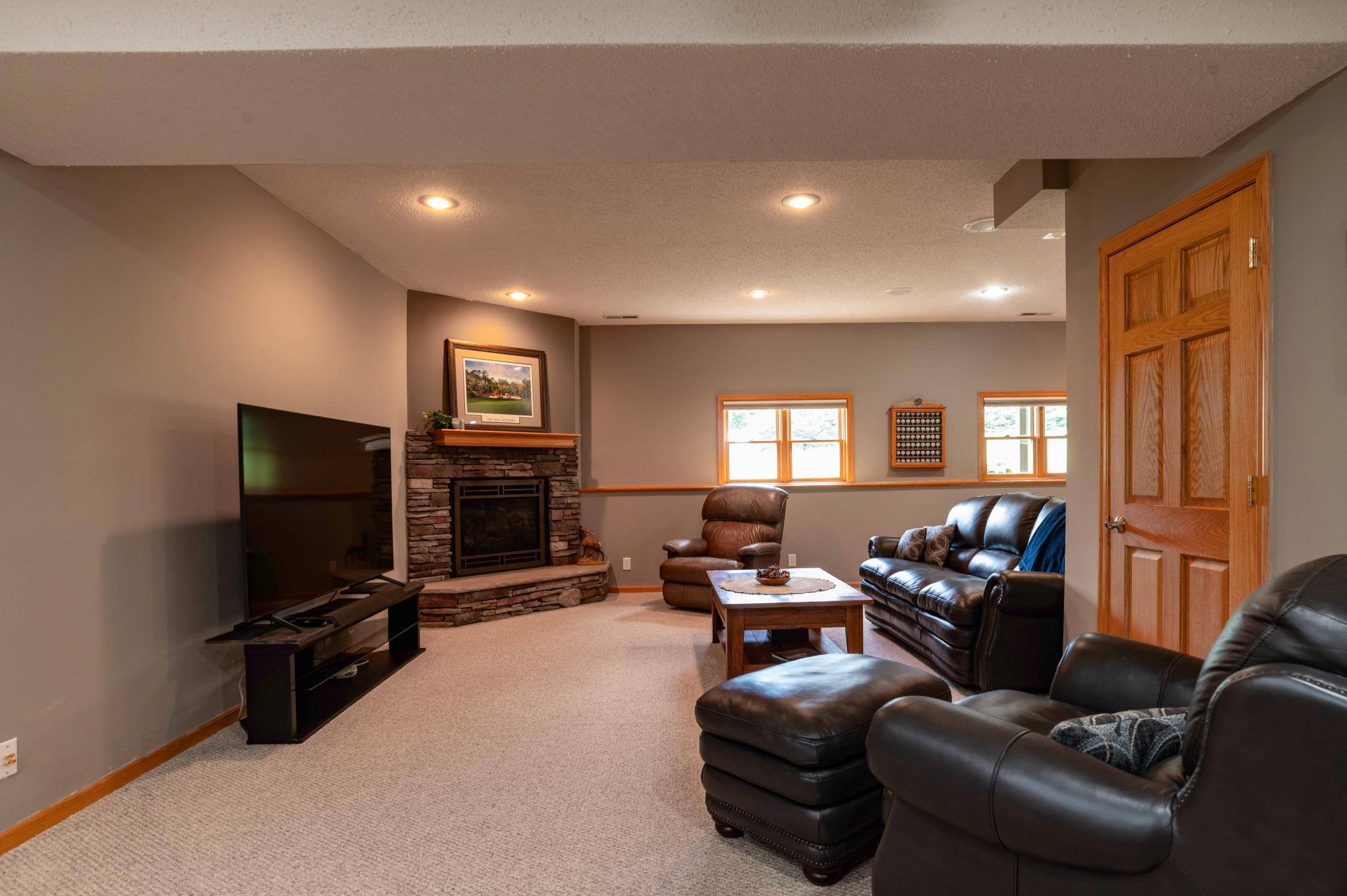 Gas burning fireplace with stone surround is thermostat controlled to make it cozy.jpg