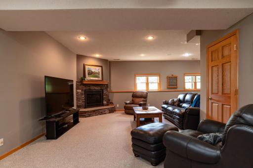 Gas burning fireplace with stone surround is thermostat controlled to make it cozy.jpg