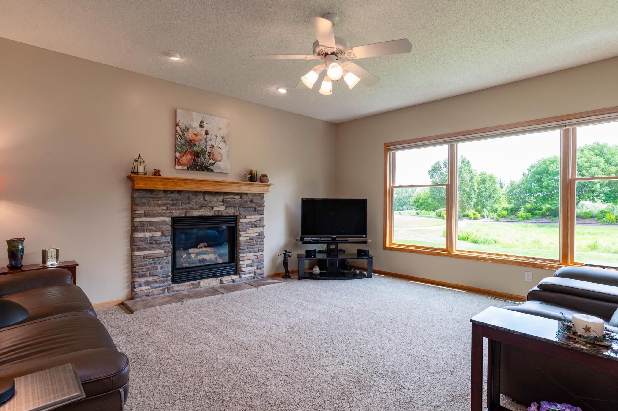 Main level living room with gas burning fireplace and million dollar views.jpg