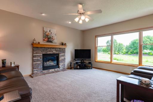 Main level living room with gas burning fireplace and million dollar views.jpg