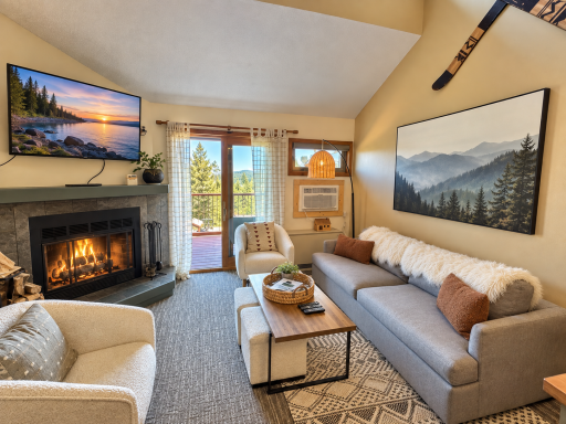 Living room with wood burning fireplace and views of Moose Mtn.png
