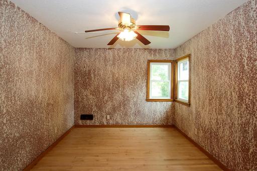 The main floor bedroom is good sized and has unique texturing over the paint. It also has a full wall of closet space.