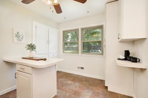 Large vinyl windows in the kitchen, plenty of storage & room for a breakfast table