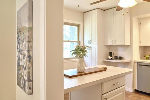 Spacious and bright kitchen has white enamel cabinetry