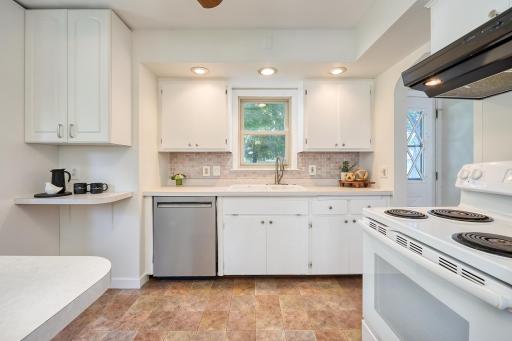 Spacious and bright kitchen with white enamel cabinetry