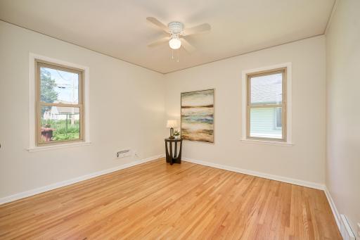 Main-floor bedroom with attractive, well-maintained hardwood flooring.