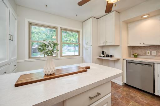 Spacious and bright kitchen has white enamel cabinetry