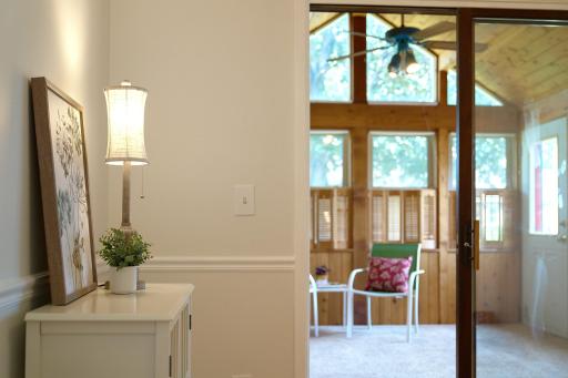 Formal dining room opens to the vaulted 3-season porch