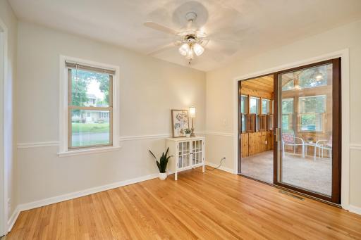 Formal dining room opens to the vaulted 3-season porch. The dining room also has direct access to the kitchen, and the hallway to the living room and restroom.
