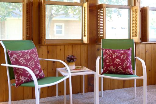 3-season porch is lined with windows and overlooks the deck and gardens.