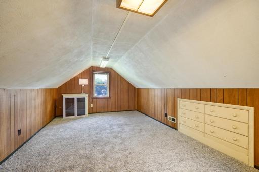 The upper-level bedroom offers flexible space for a bedroom, home office, or playroom and features a built-in dresser, plus brand-new carpet and pad.