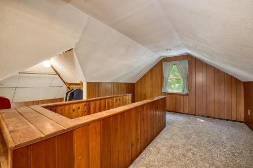 Upper-level bedroom with new carpeting and charming architectural detail.