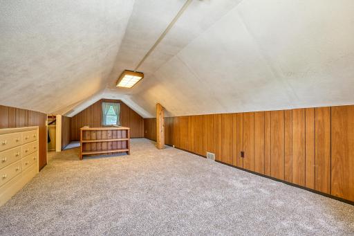 Upper-level bedroom with built-in dresser and built-in book case