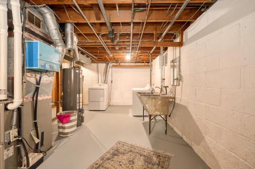 Enjoy the convenience of a lower-level utility and laundry room with abundant storage, a laundry chute just steps from the washer and dryer, and a clean, well-maintained appearance.