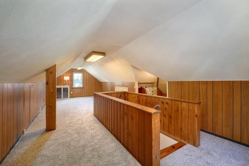 Ascending the stairs from the living room, you'll find a spacious and versatile upper-level area enhanced with brand-new carpet and pad.