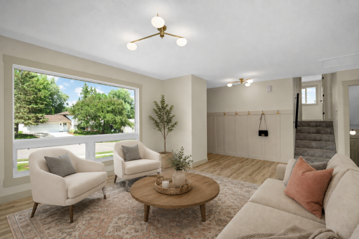 Bright open main floor living room with large new picture window. some virtual staging