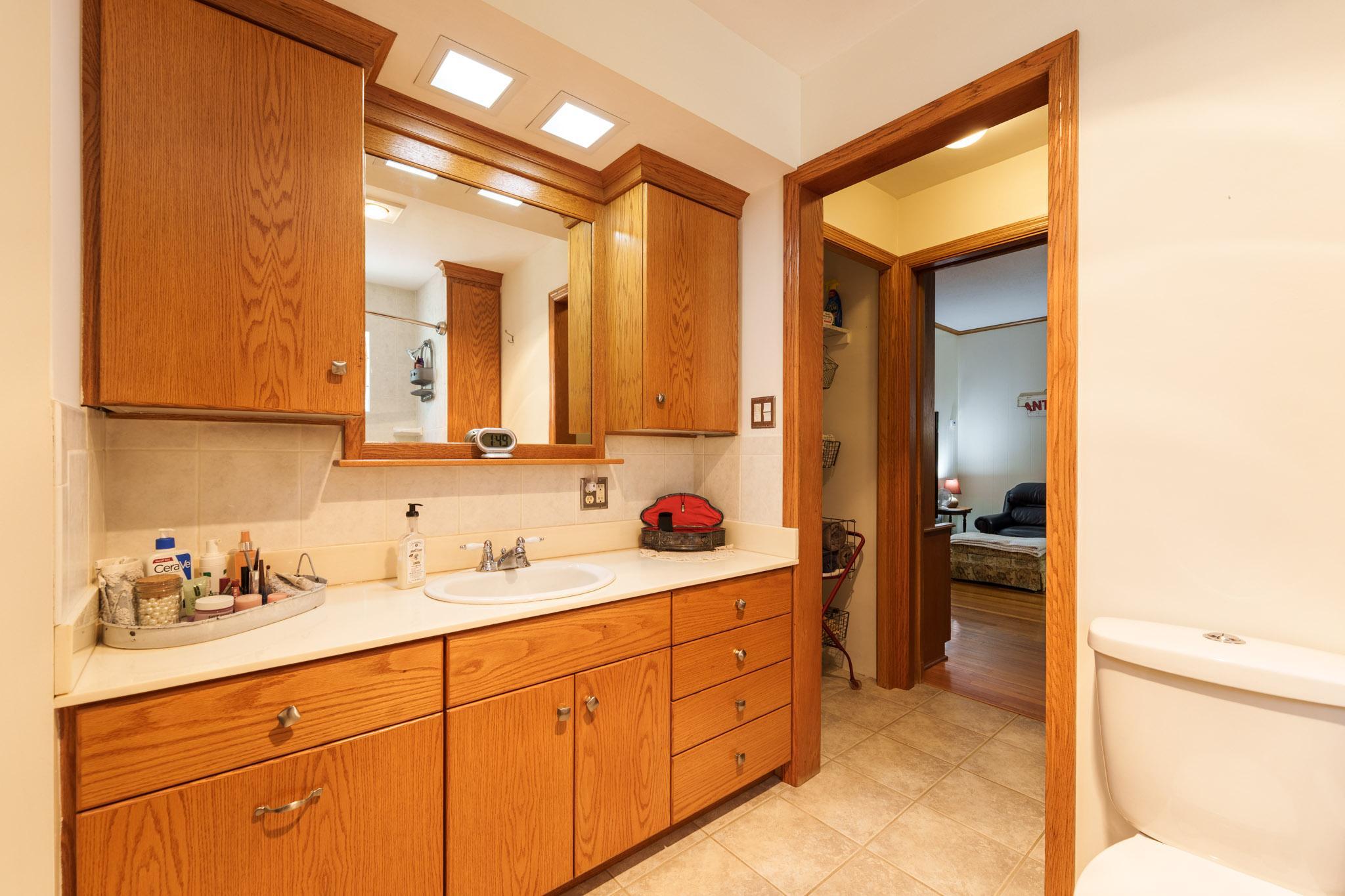 Large main floor vanity with generous cabinetry for storage,