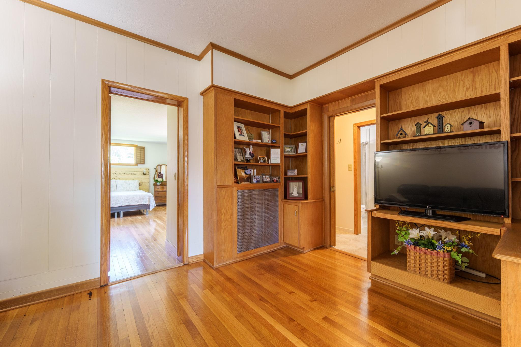 The entrance to the large main floor primary bedroom is to the left, and the door to the right leads you toward the main-floor laundry and the full bathroom.