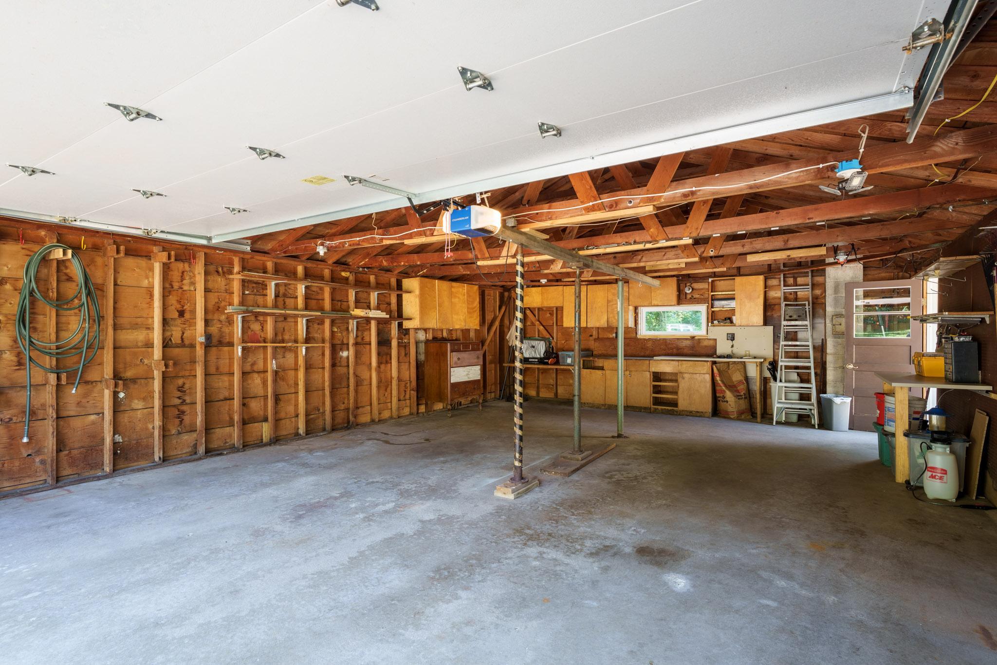 Just 'inches short of a true tandem' garage...there is ample room for parking four smaller vehicles, or two cars plus your workshop/ garden-potting area!