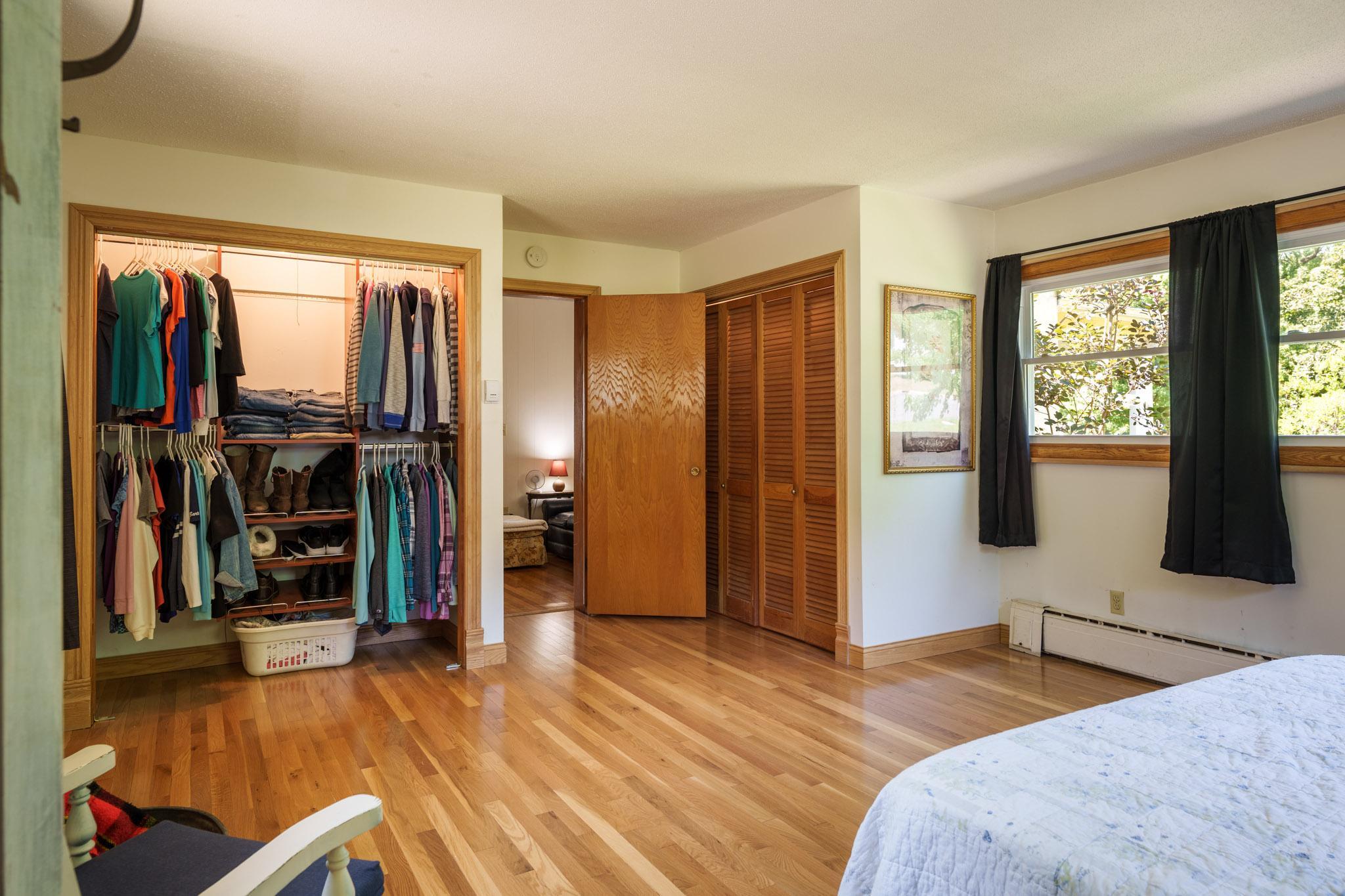 The incredible main floor primary bedroom with two large closets and literally steps from the main floor full bath!