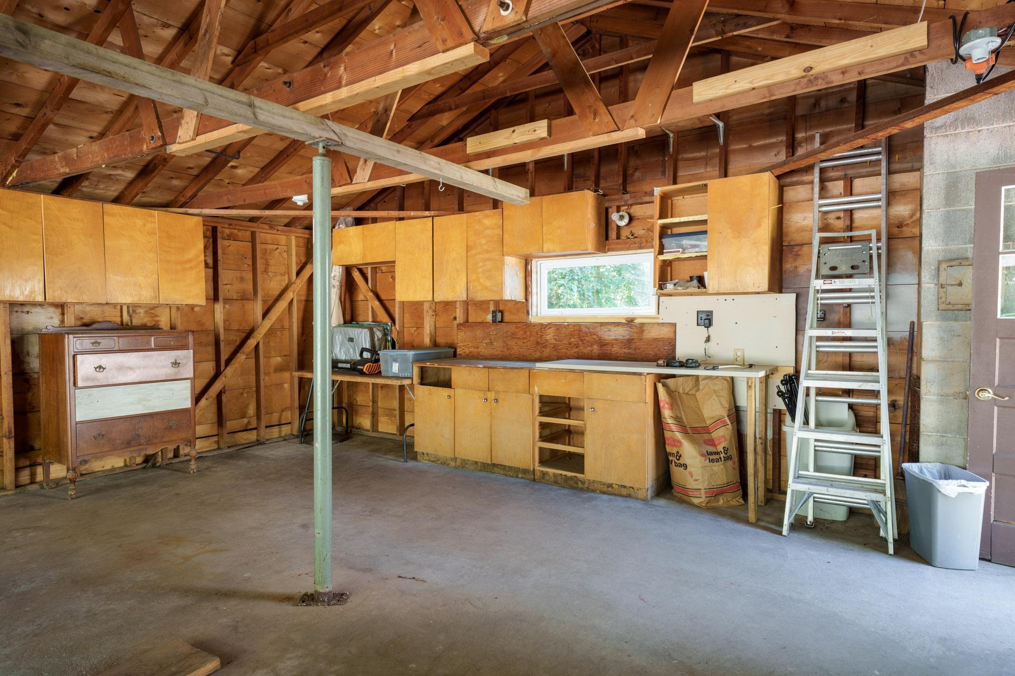 The spacious garage includes an abundance of cabinet storage.