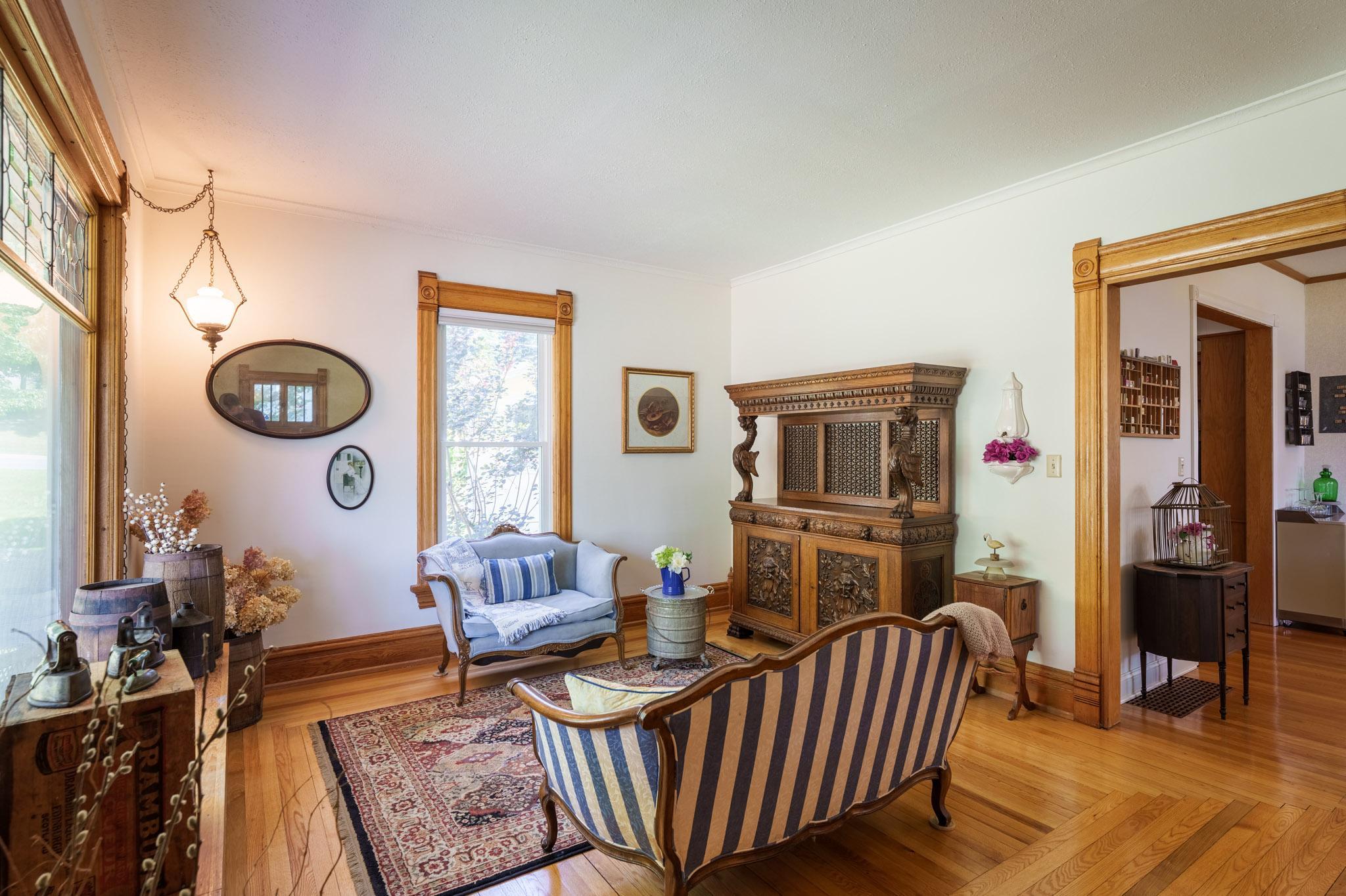 The warmth of the original woodwork, the gleaming hardwood floors, and the abundance of natural light, envelop you!