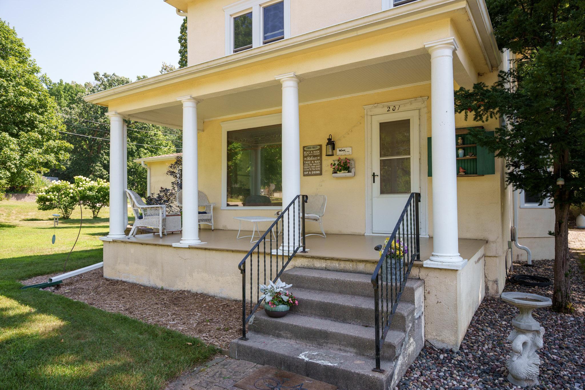 The covered porch beckons you in as you approach the front door of this stately home!