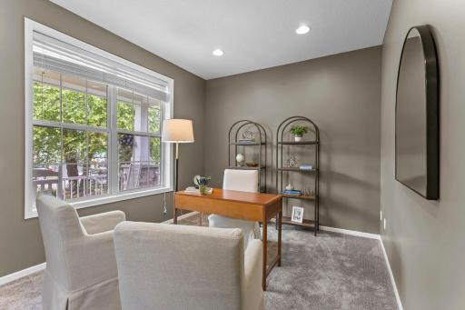 A welcoming foyer with 18-ft ceilings creates a lasting first impression. Just off the entry, a private office with glass French doors.
