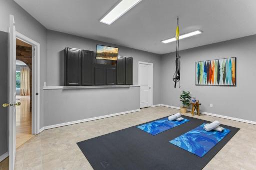 The finished lower level exercise room offers a dedicated fitness or sports space.