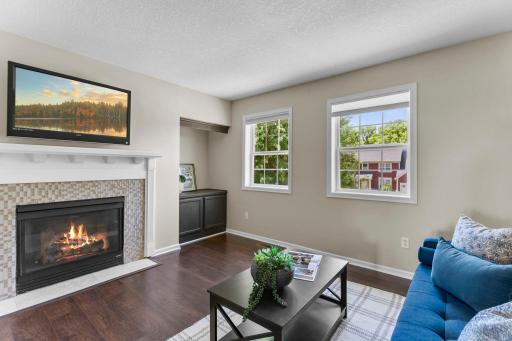 Connected to the primary suite is one of the home's most versatile spaces: a flex room with a gas fireplace.