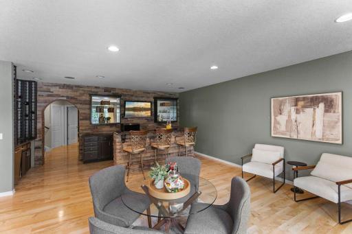 A stone archway opens to a spacious, light-filled family room.