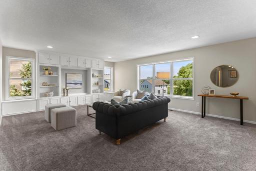 Upstairs, a spacious loft-style landing with built-in cabinetry, bench seating with hidden storage, and abundant natural light.