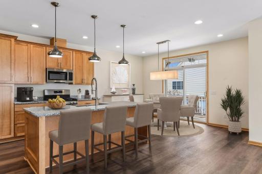 Sun-filled end unit is completely remodeled from top to bottom! Center island adds additional seating and storage. (Virtually Staged)