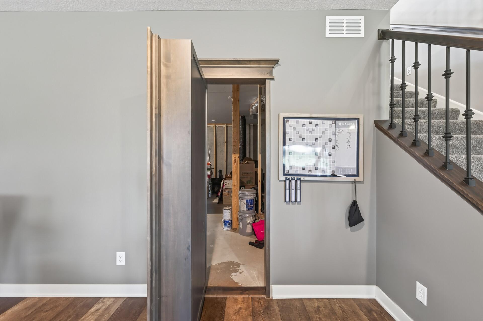 Utility room is hidden behind the downstairs bookshelf. The lower level is roughed in for a future theater/media room