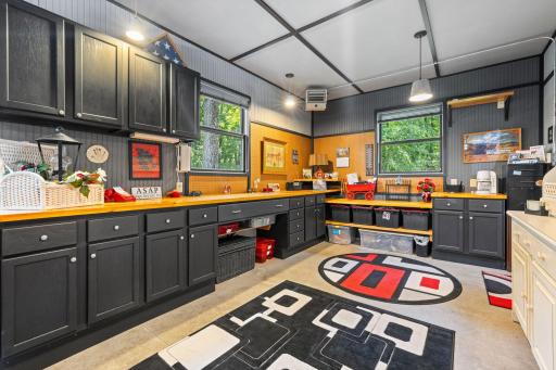 Third stall garage space is heated and insulated. Set up for a great hobby space with built-in cabinets.