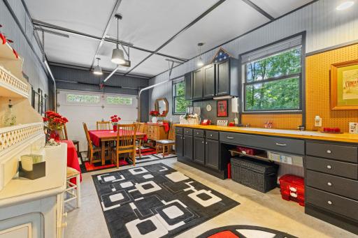 Third stall garage space is heated and insulated. Set up for a great hobby space with built-in cabinets.