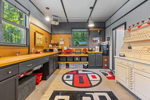Third stall garage space is heated and insulated. Set up for a great hobby space with built-in cabinets.