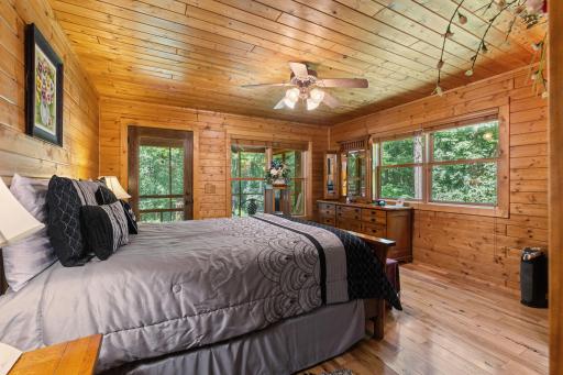 Primary bedroom with door to the screen porch