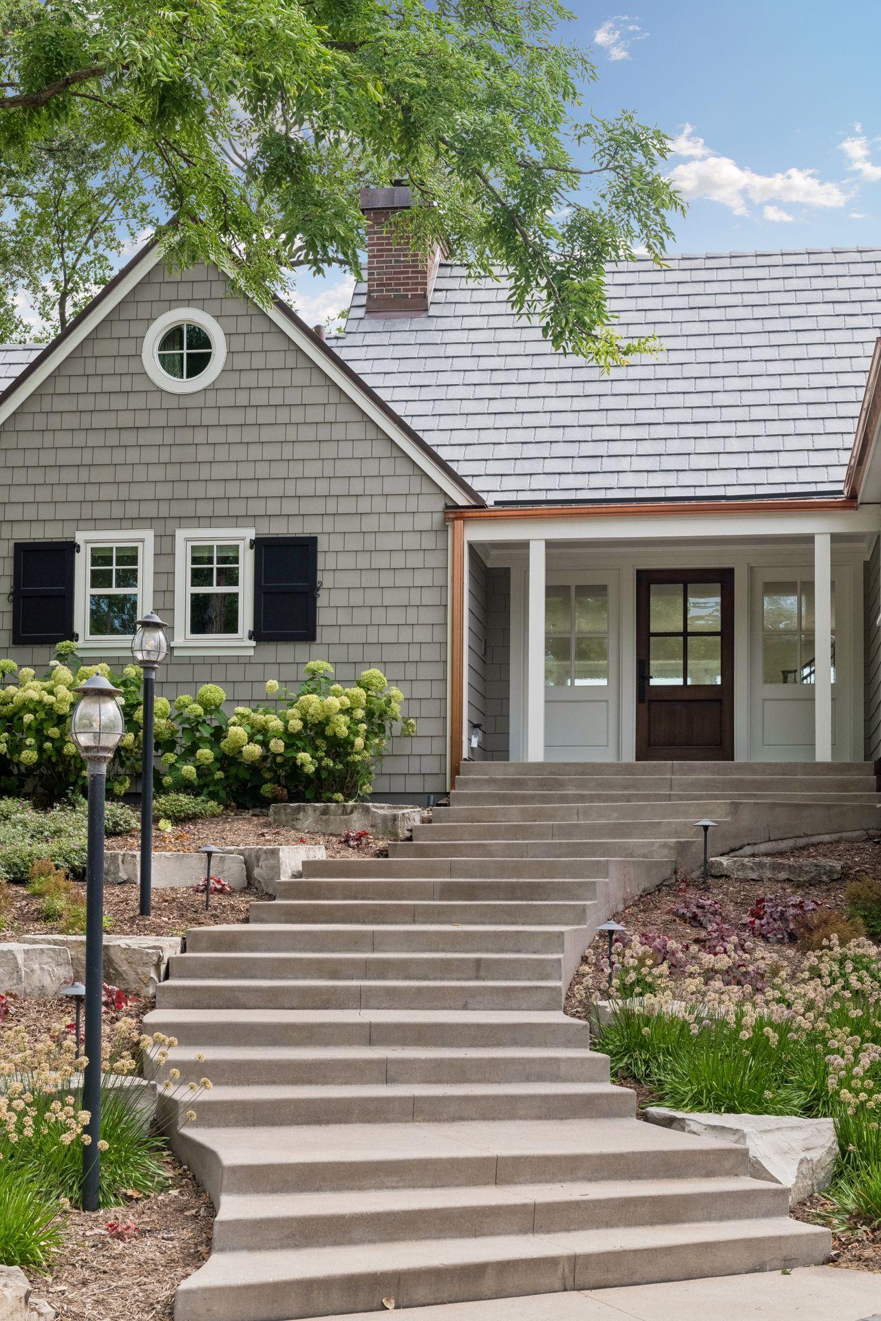 Stylish copper gutters and paver driveway