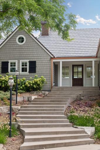 Stylish copper gutters and paver driveway