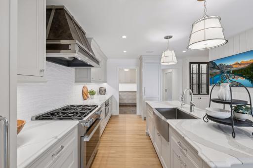 Kitchen features high end stainless steel appliances, spacious center island, and a walk-in pantry that was added