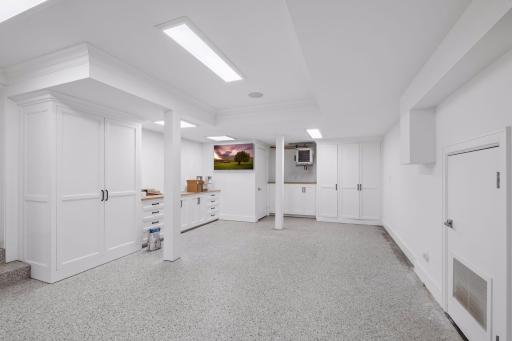 3 car garage - heated, epoxy flooring, and plenty of storage and space to hang out with