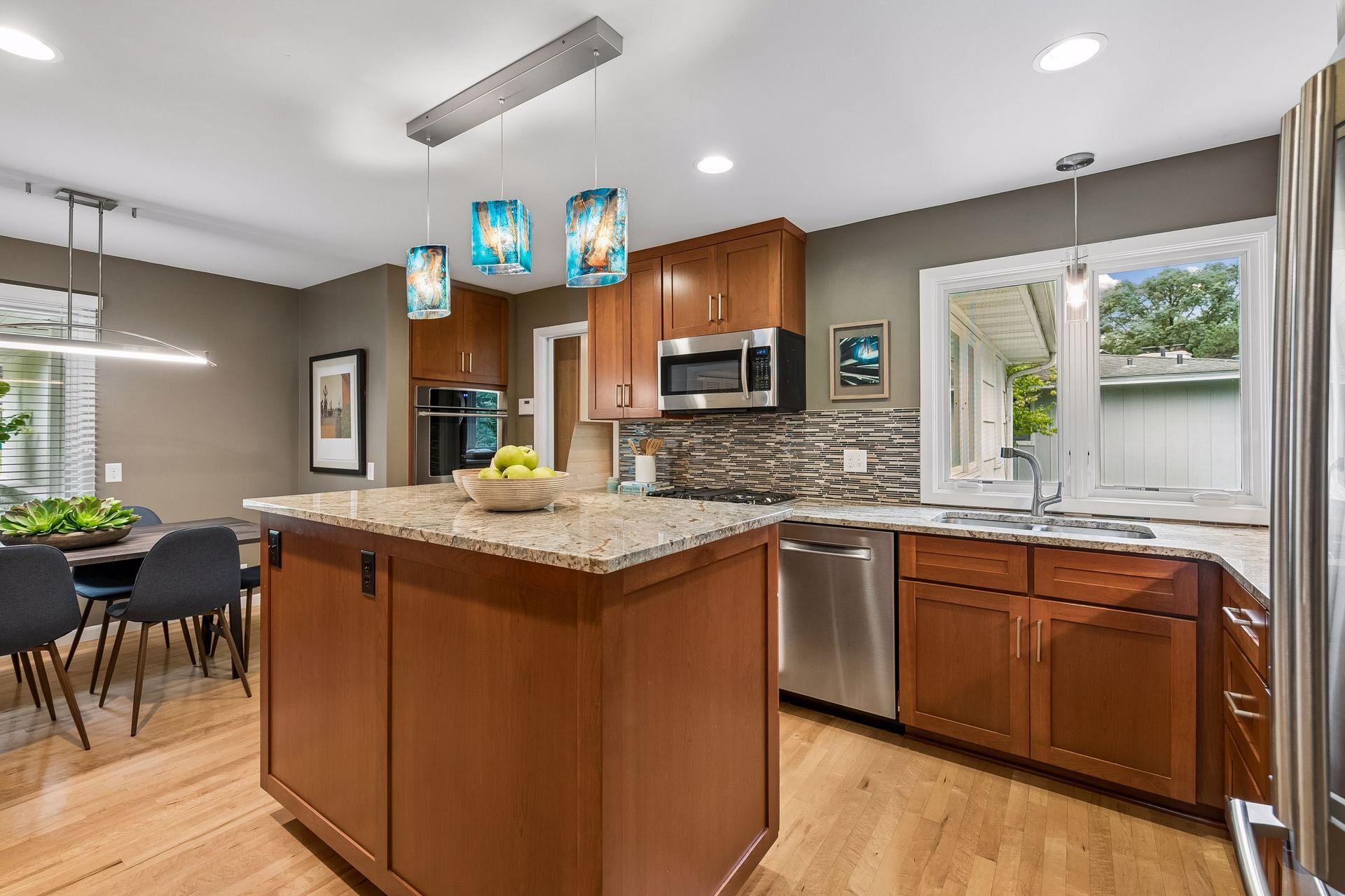The kitchen features custom cabinets, two ovens, and granite countertops