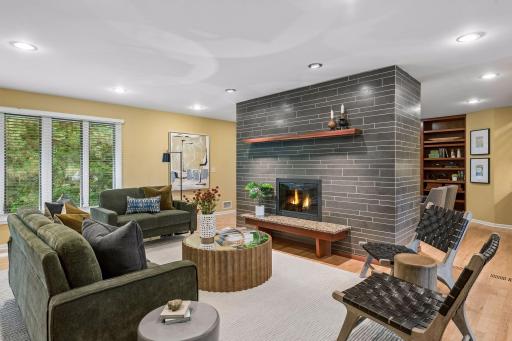 Gas Fireplace flanks the living room and cozy den